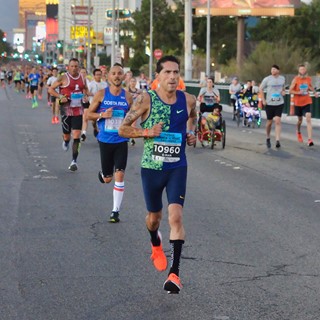 Participants are shown running southbound on the Strip