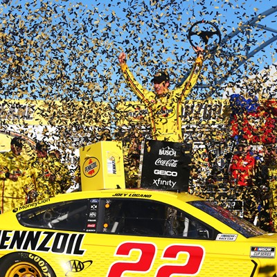 Joey Logano (22) celebrates after winning the NASCAR Cup Series Pennzoil 400