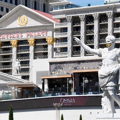 Statue of Caesar wears a mask in front of Caesars Palace