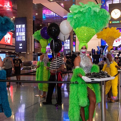 Las Vegas Showgirls and a Venetian Las Vegas Gondolier hand out masks at McCarran International Airport June 26, 2020