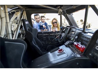 A family checks out the interior of one of the racers in Las Vegas as the Mint 400 4 Wheel Parts Vehicle Procession