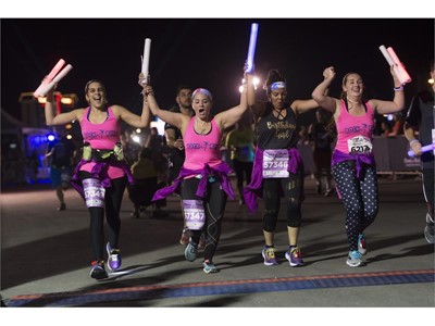 A group of women cross the finish line during the Rock 'n' Roll Las Vegas Marathon 5K run