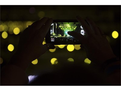 A fan takes a photo of the Goo Goo Dolls performing during the Rock 'n' Roll Las Vegas Marathon 5K run