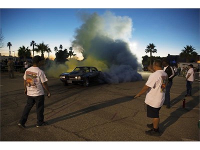 Tom Thiessen sends up clouds of yellow and blue smoke from the tires of his 1969 Camaro