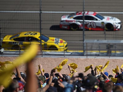 Fans wave Pennzoil flags during the Monster Energy NASCAR Cup Series Pennzoil 400