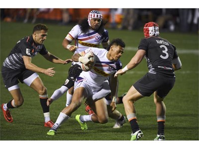 Maka Unufe of the US makes his way through England's defense during their match at the USA Sevens Rugby tournnament