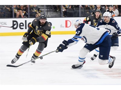 Vegas Golden Knights right wing Alex Tuch gets a pass by Winnipeg Jets defenseman
