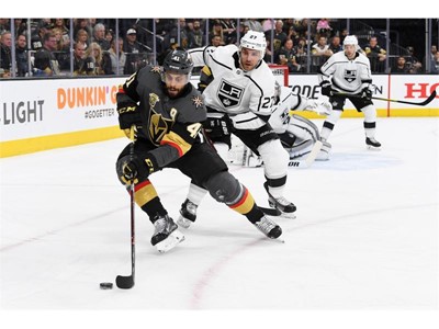 Vegas Golden Knights left wing Pierre-Edouard Bellemare is defended by Los Angeles Kings defenseman