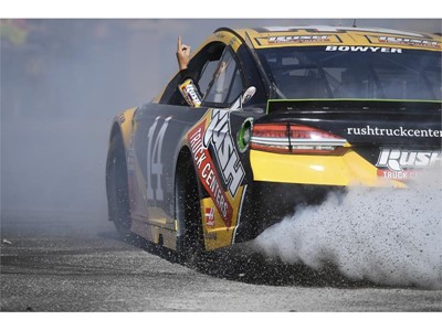 Clint Bowyer (14) points to the sky while doing donuts during the 2018 NASCAR Burnout Blvd