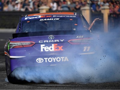 Denny Hamlin (11) throws smoke and rubber during the 2018 NASCAR Burnout Blvd