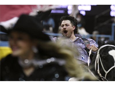 Wyatt Denny celebrates his first place finish in bareback riding