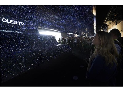 Attendees walk through the entry to the LG booth