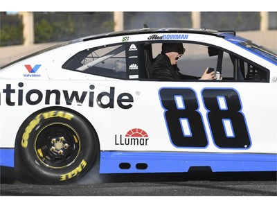 A passenger in Alex Bowman's car