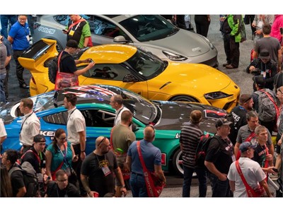 Visitors crowd cars on display