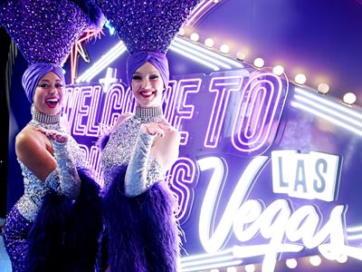 Showgirls in front of Fabulous Pickups Sign