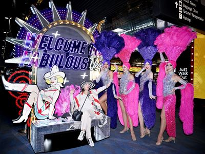 Showgirls With Visitor Taking Photo