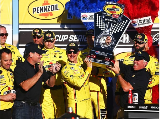 Joey Logano (22) is presented with a trophy after winning the NASCAR Cup Series Pennzoil 400 Joey Logano (22) is presented with a trophy after winning the NASCAR Cup Series Pennzoil 400