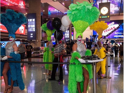 Las Vegas Showgirls and a Venetian Las Vegas Gondolier hand out masks at McCarran International Airport June 26, 2020 Las Vegas Showgirls and a Venetian Las Vegas Gondolier hand out masks at McCarran International Airport June 26, 2020