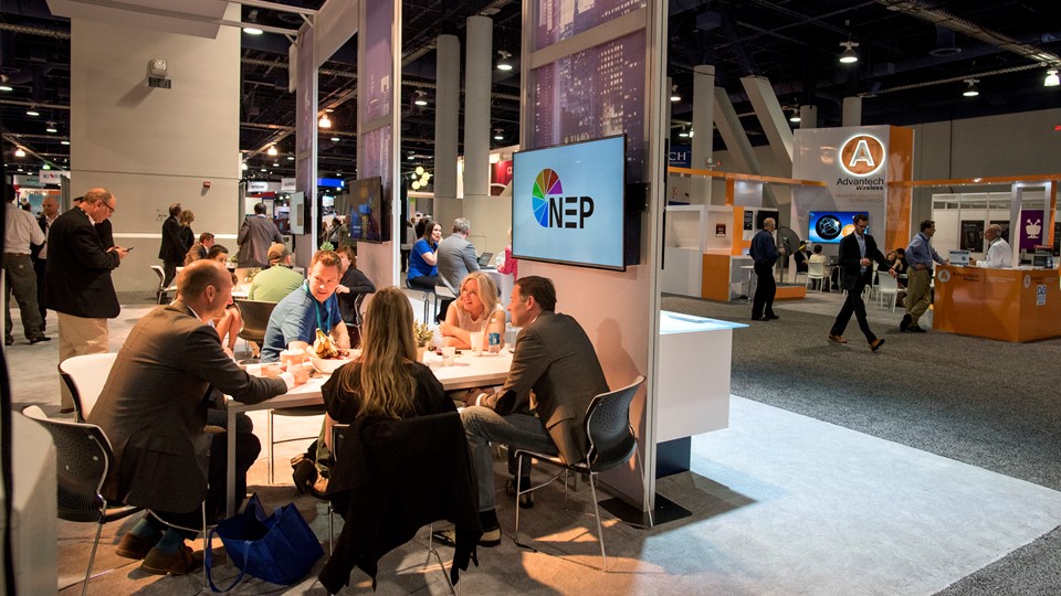 Salespeople meet in the NEP broadcast technology booth