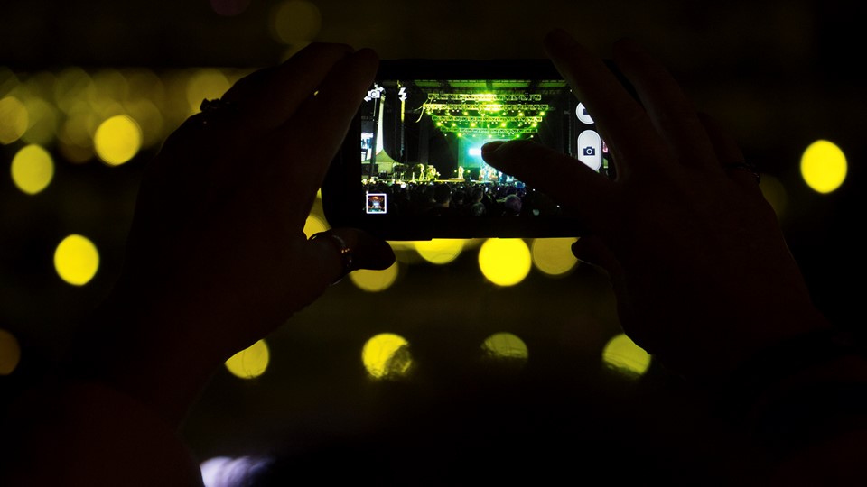 A fan takes a photo of the Goo Goo Dolls performing during the Rock 'n' Roll Las Vegas Marathon 5K run