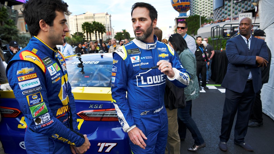 NASCAR Cup Series driver Jimmie Johnson, right, talks with Chase Elliott