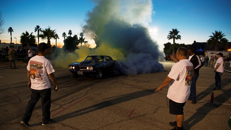 Tom Thiessen sends up clouds of yellow and blue smoke from the tires of his 1969 Camaro