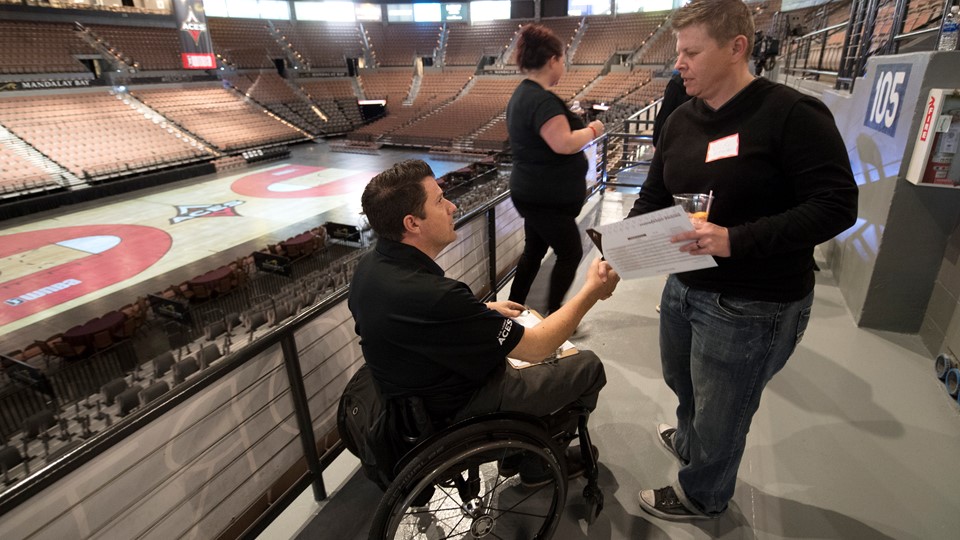 Las Vegas Aces Director of sales Aaron Johnson talks with a fan