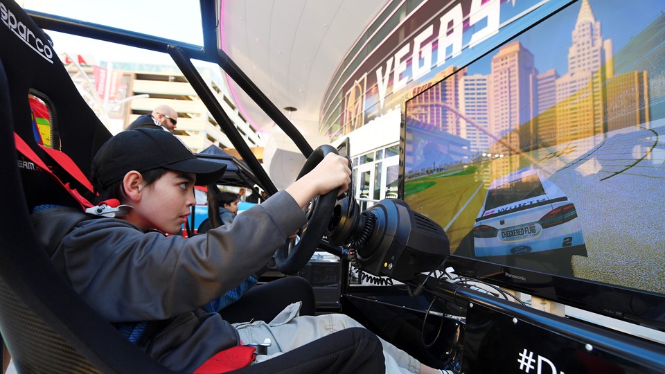 Ethan Chase of Las Vegas tries out a driving simulation