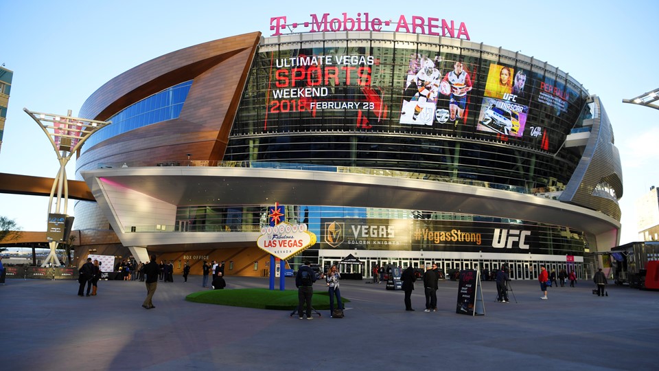 A banner ad on the side of T-Mobile Arena announces the Ultimate Vegas Sports Weekend pep rally