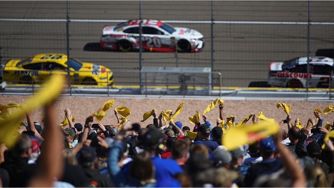 Fans wave Pennzoil flags during the Monster Energy NASCAR Cup Series Pennzoil 400