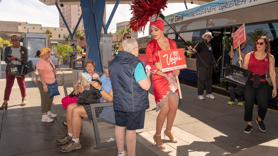 Las Vegas showgirl Porsha Revesz greets riders at the Bonneville RTC Transit Stations