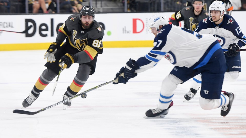 Vegas Golden Knights right wing Alex Tuch gets a pass by Winnipeg Jets defenseman