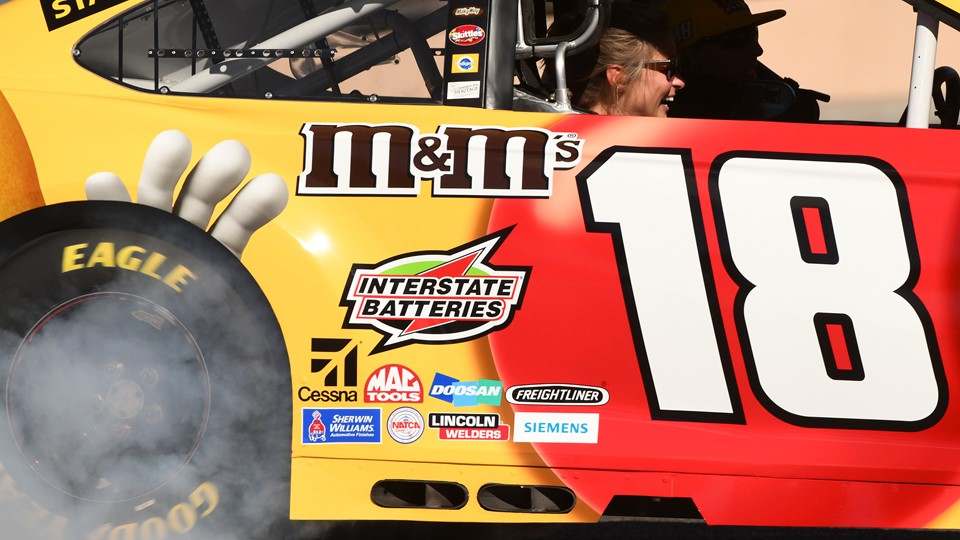 A passenger laughs while riding in Kyle Busch's car during the 2018 NASCAR Burnout Blvd