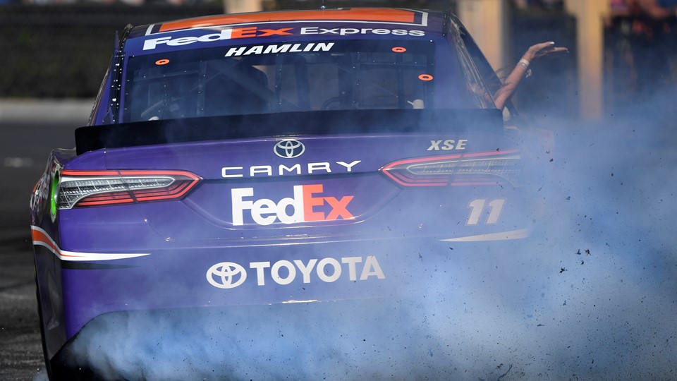 Denny Hamlin (11) throws smoke and rubber during the 2018 NASCAR Burnout Blvd