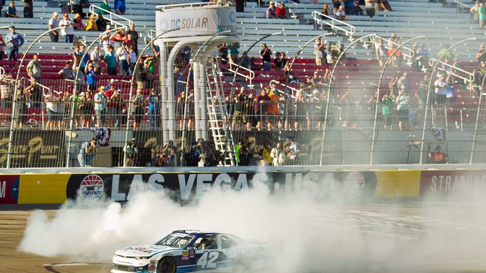 Ross Chastain #42 does a burnout at the finish line after winning the NASCAR Xfinity Series DC Solar 300