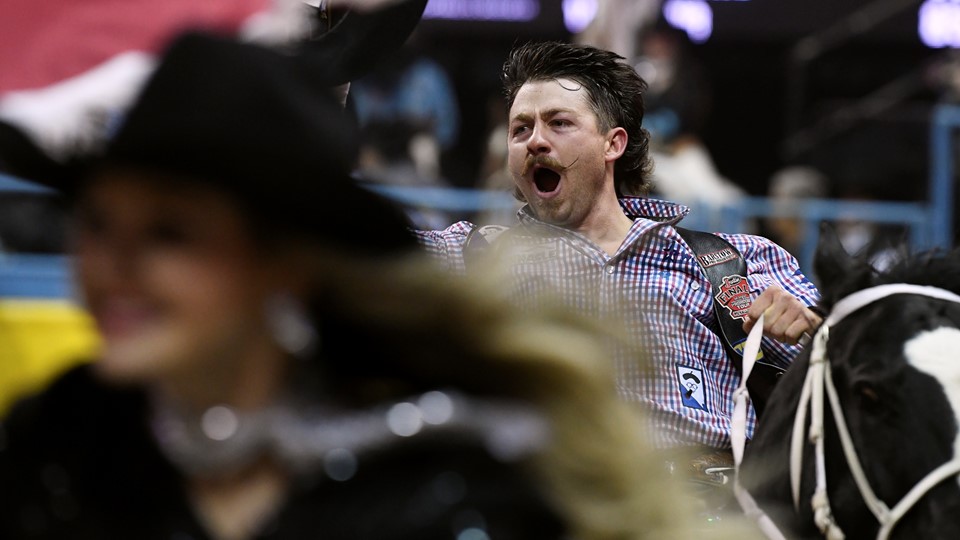Wyatt Denny celebrates his first place finish in bareback riding