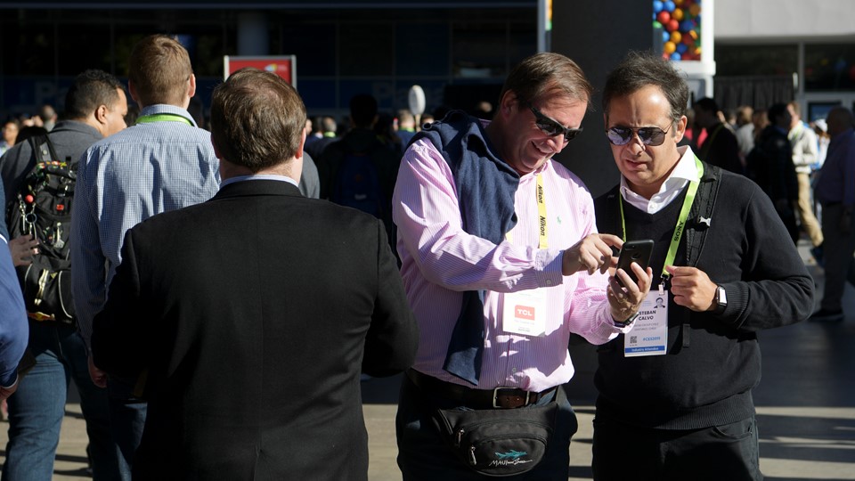 Attendees check their phone