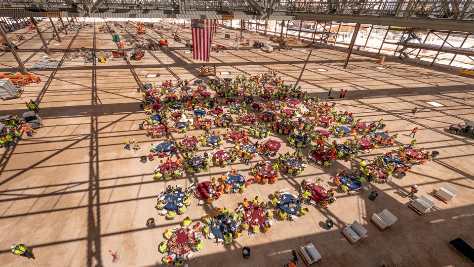 Workers gather inside the new exhibit hall as Turner/Martin-Harris recognizes its tradespeople