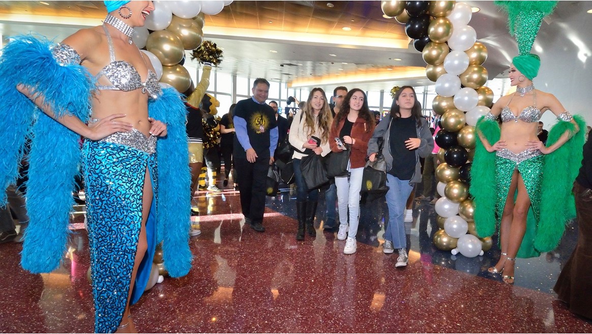 Brand ambassadors Carolin Feigs, left, and Greta Jones greet passengers from Allegiant Airlines flight 91