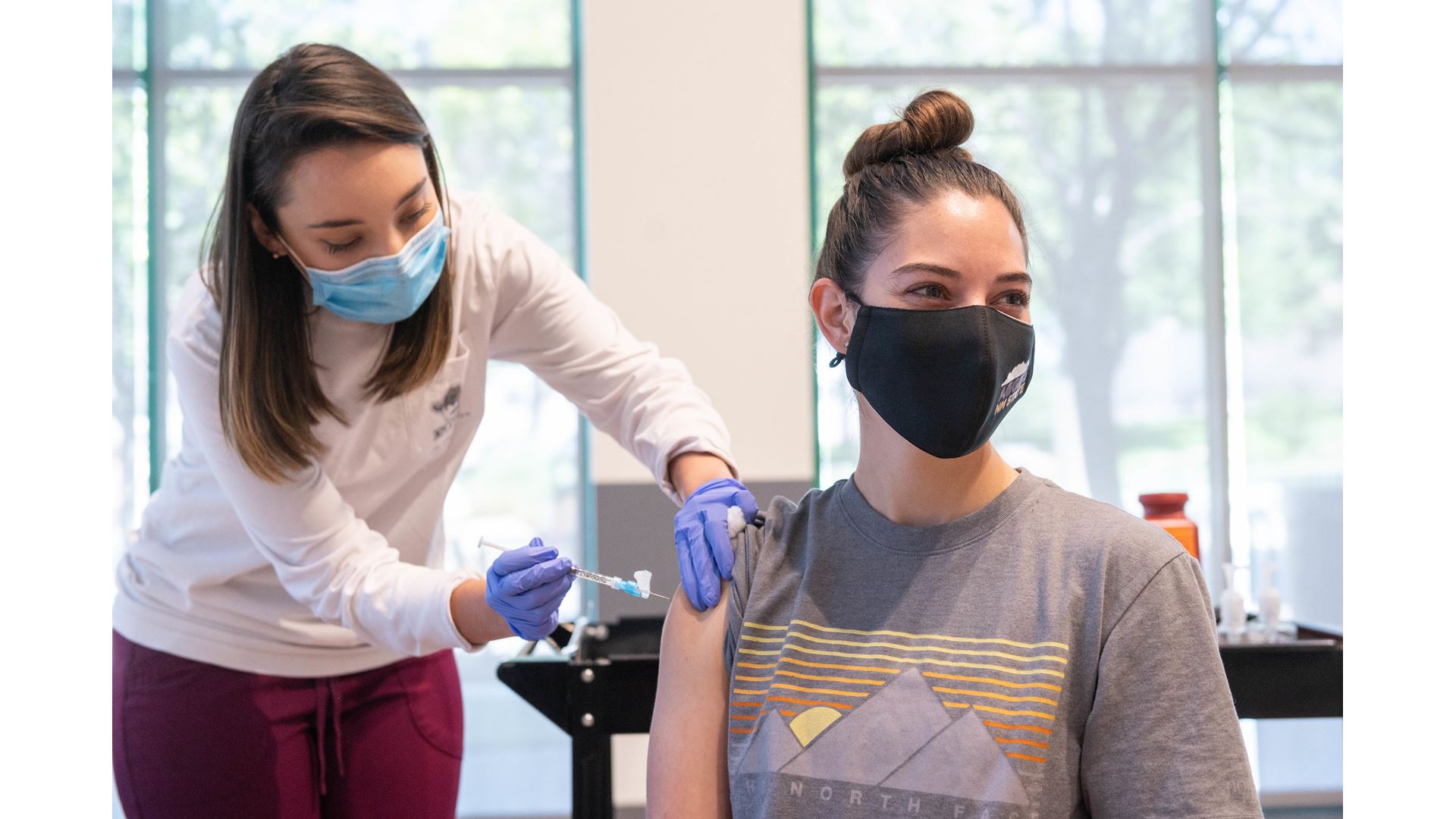 Aggie Health and Wellness Center nurse Marissa Archuleta administers a Johnson and Johnson COVID-19 vaccine to Lauren Na