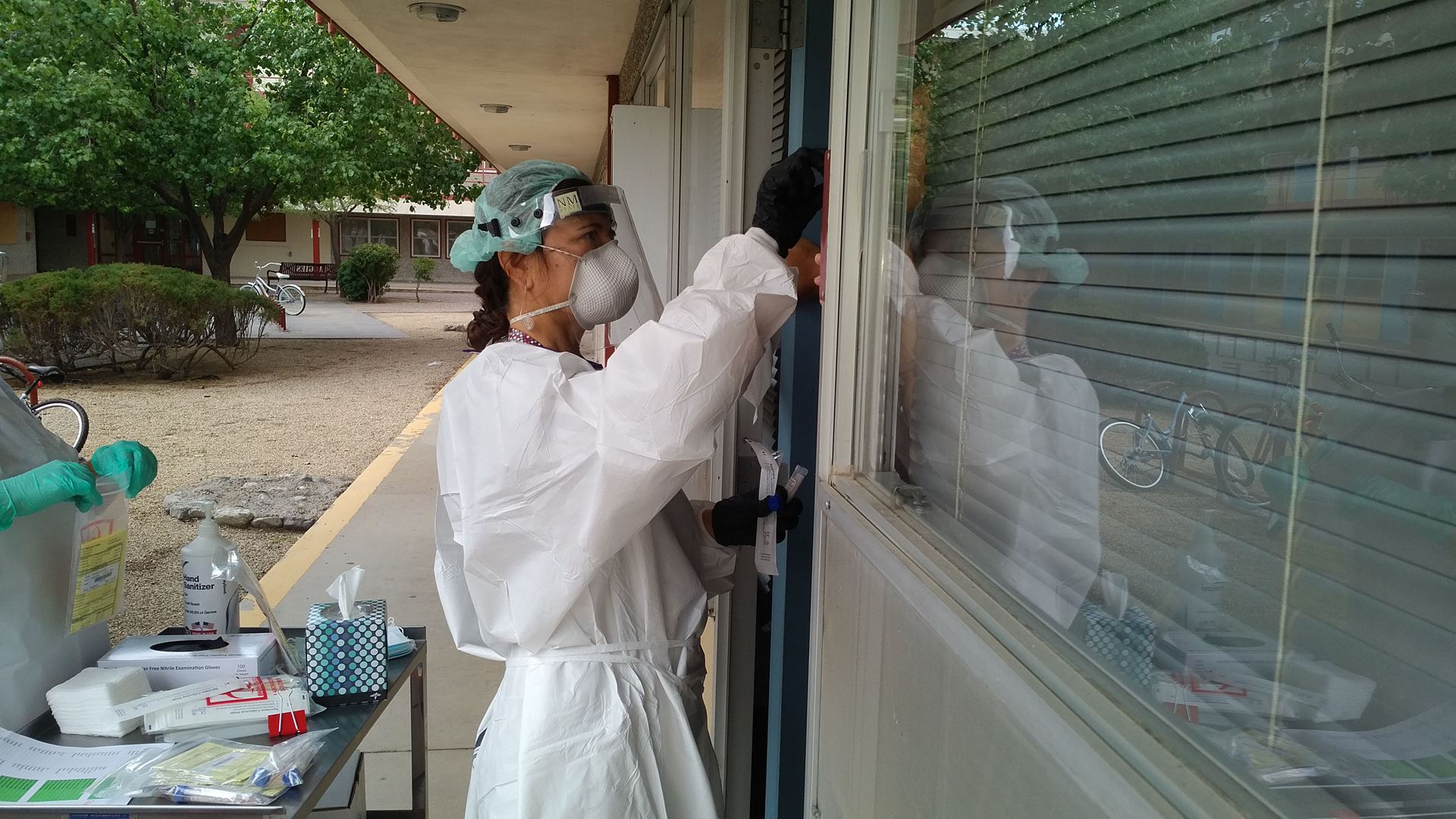 Staff member takes COVID-19 swab from out-of-state resident student at a dorm room at New Mexico State University. NMSU