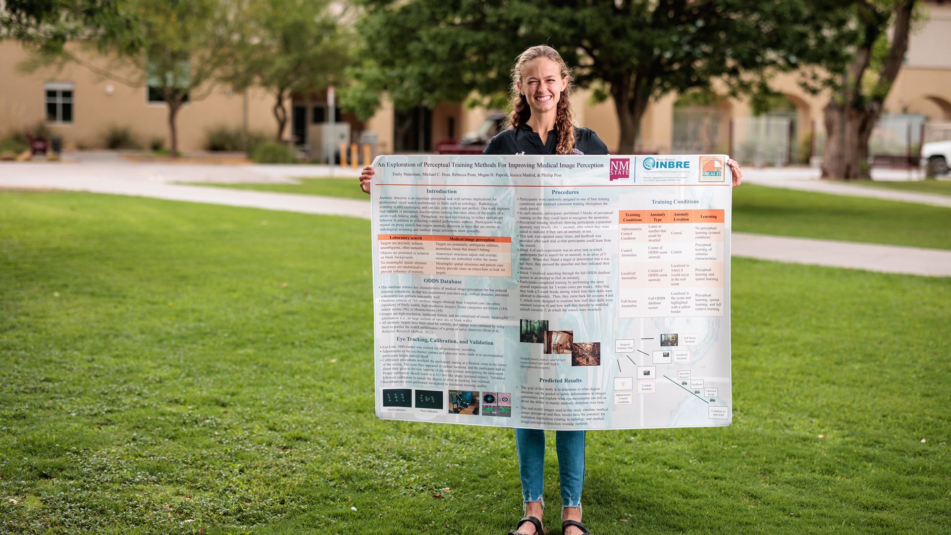 IMAGE DESCRIPTION Woman holding a research project poster