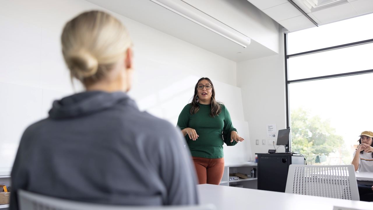 A woman presenting information to employees