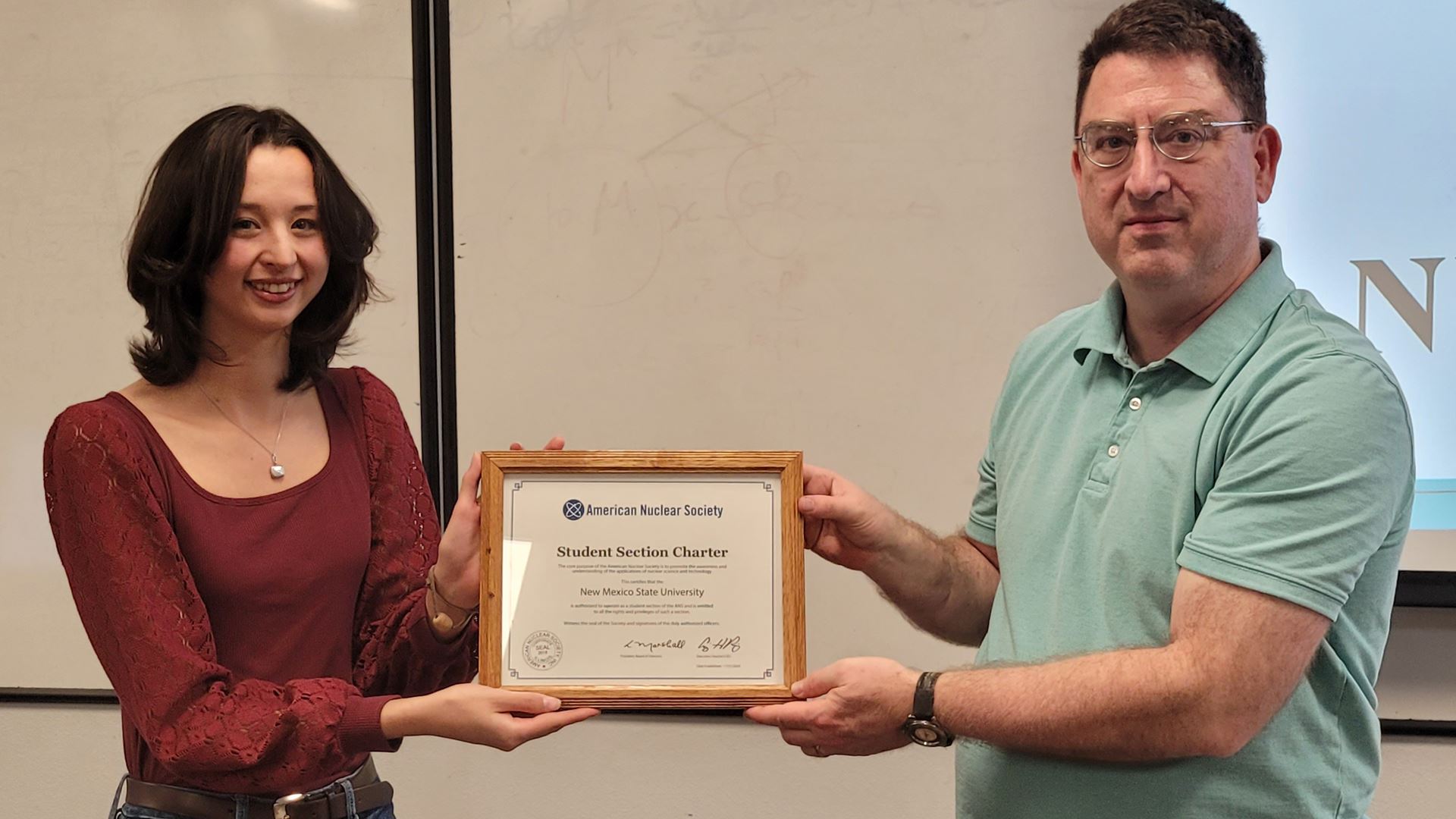 Photo of Olivia Belian and Joseph Holles with official chapter certificate