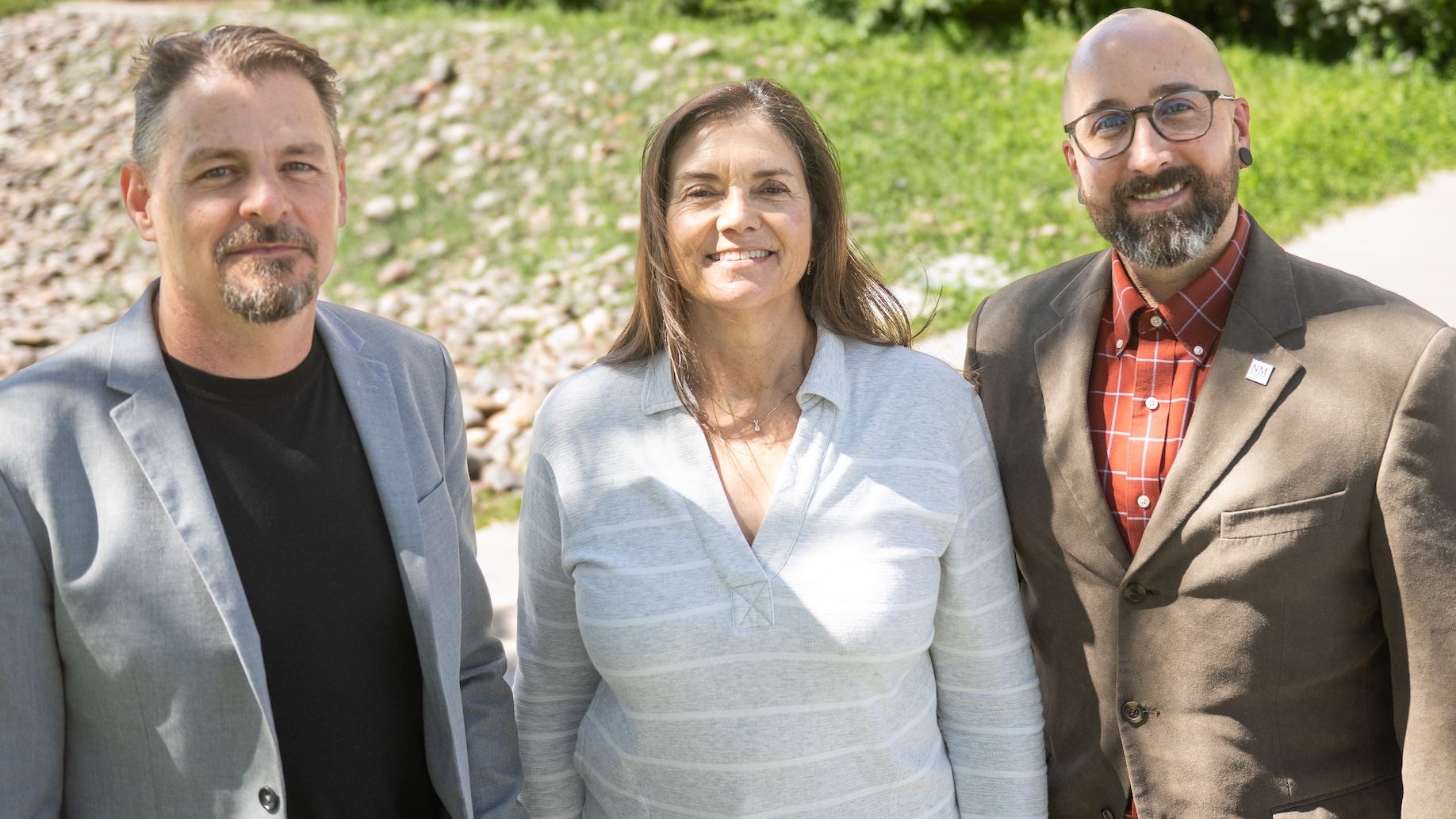 IMAGE DESCRIPTION Three people standing outdoors