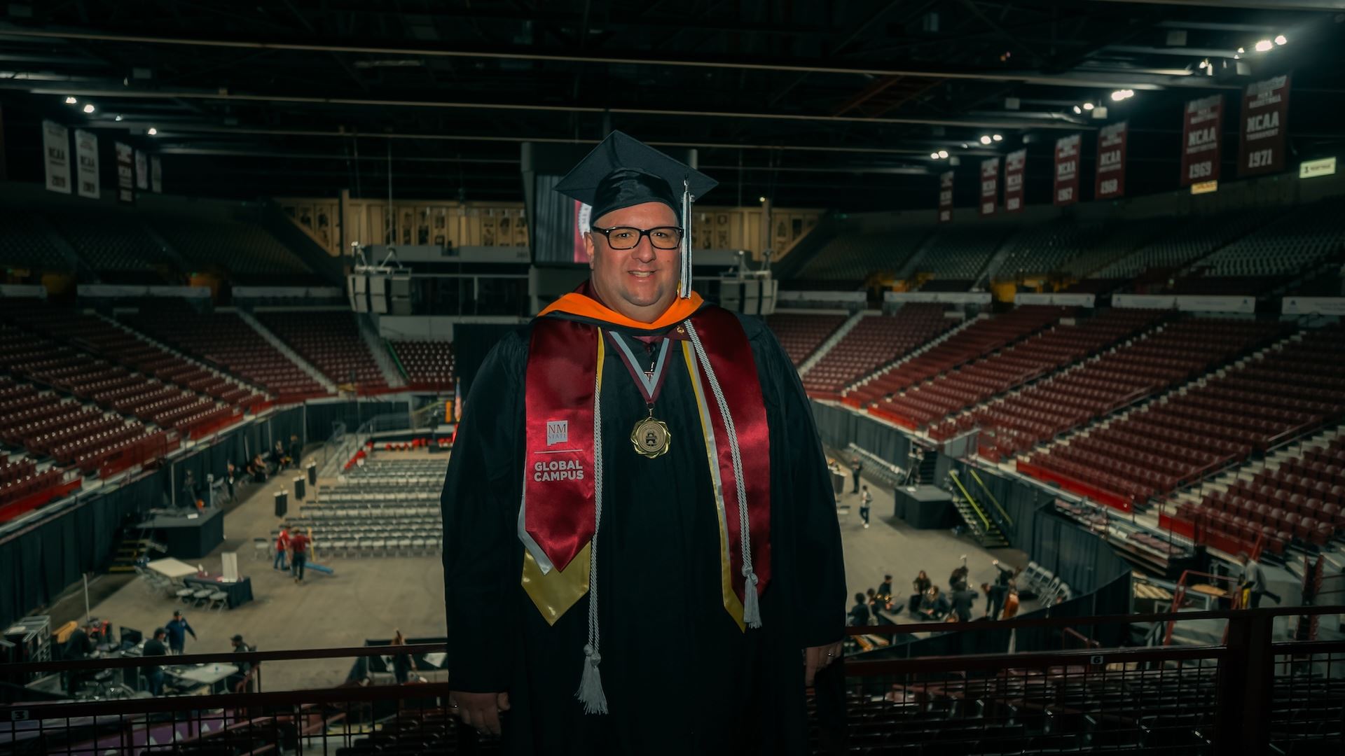 IMAGE DESCRIPTION Man wearing a commencement cap and gown