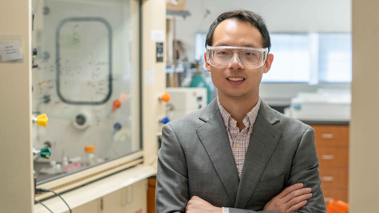 Man standing in a lab with his arms crossed