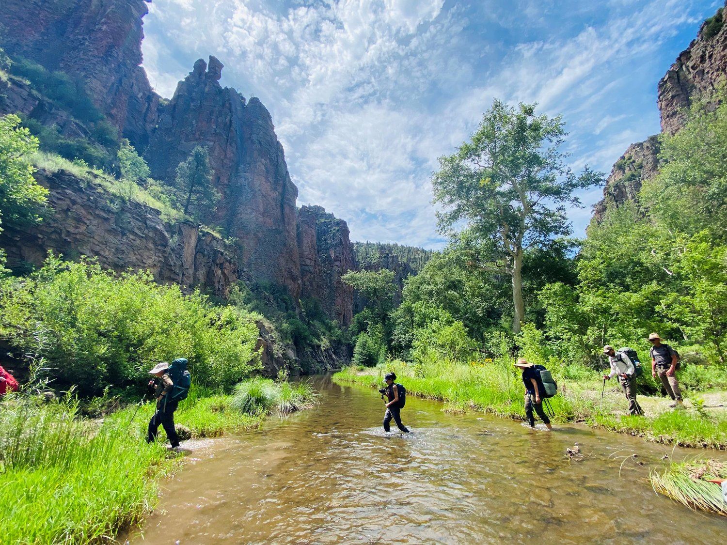A group of students crossing a river