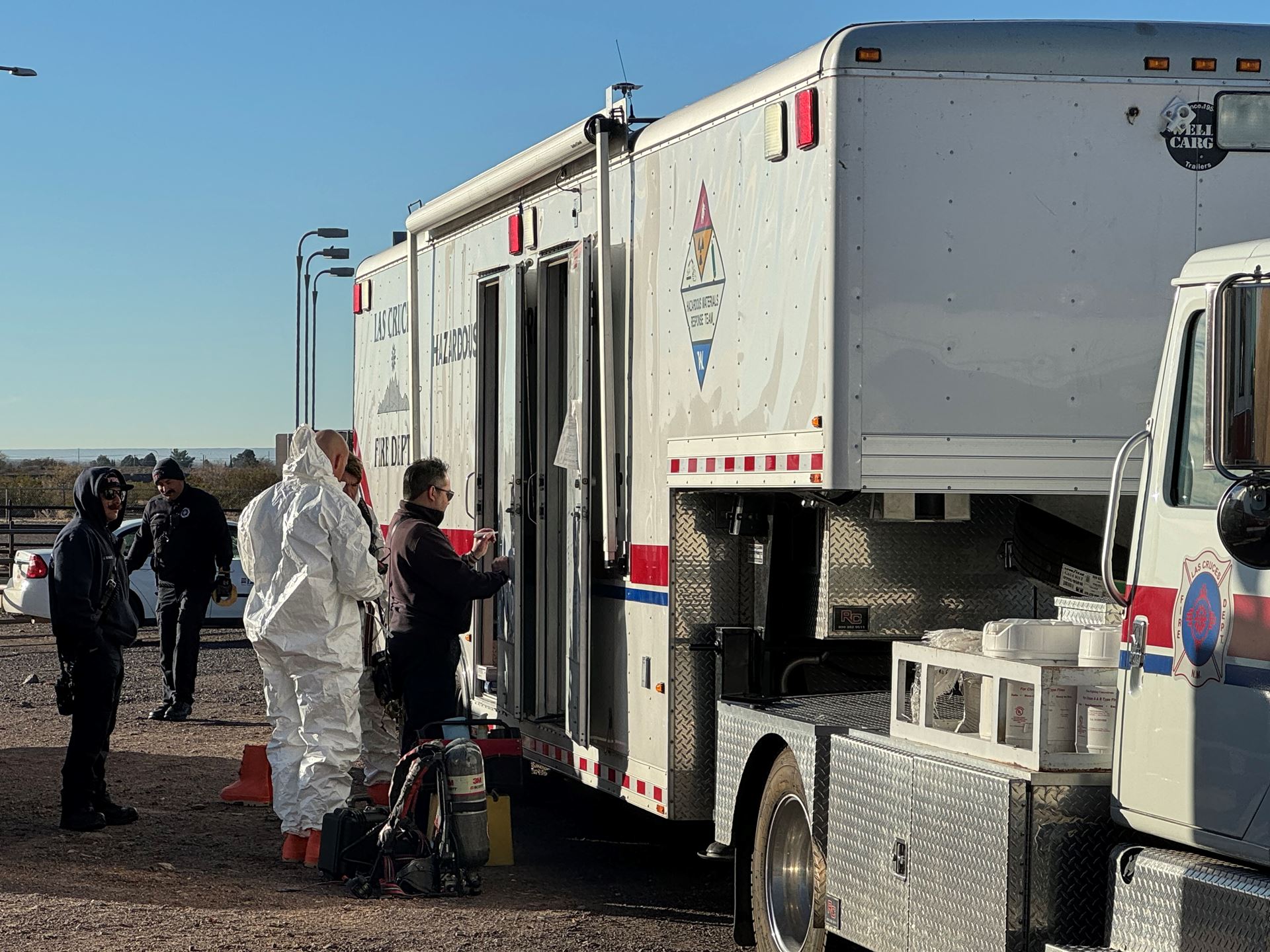 Four people standing next to an emergency vehicle