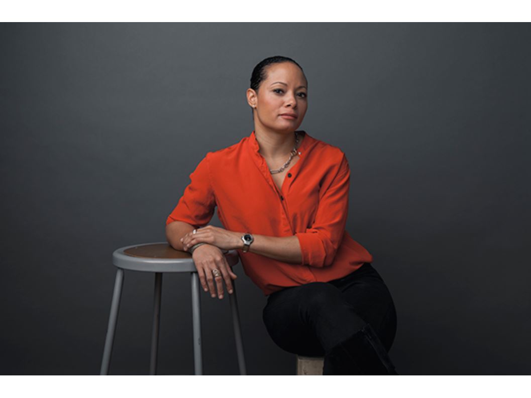 A woman leaning on a chair